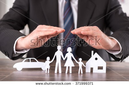 man with hands hovering above a paper cut out family